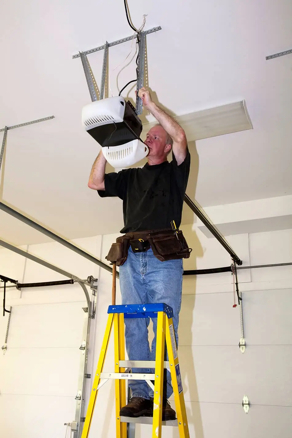 garage door tech working on opener with the lid open