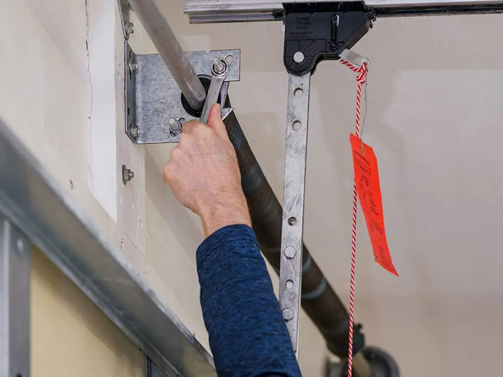 repair garage door spring with wrench
