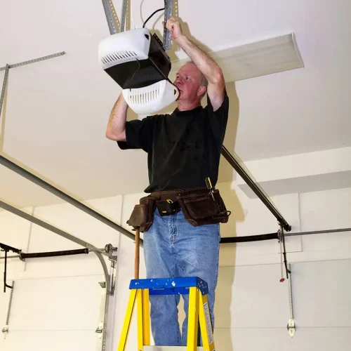 garage door tech working on opener with the lid open