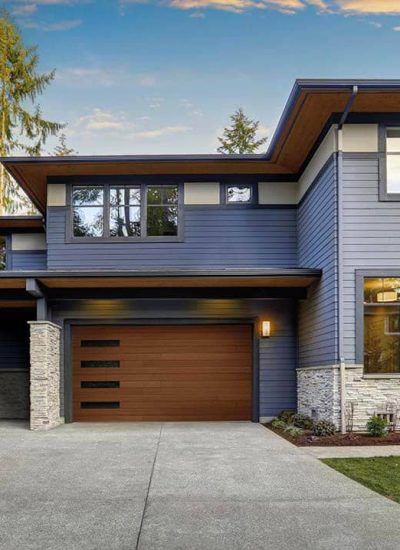 house with brown garage door and window column on the left