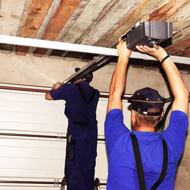 garage door technicians installing an opener