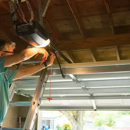 person working on repairing garage door opener chain