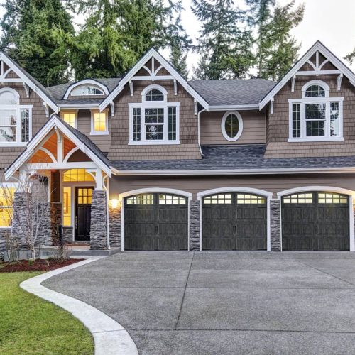 house with three gray garage doors