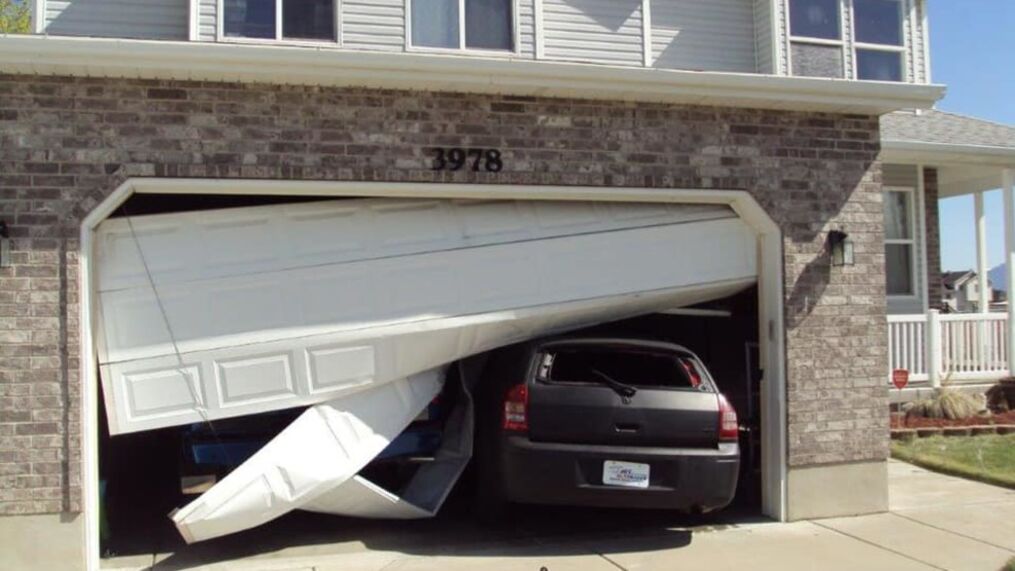 How Do I Fix My Garage Door That I Ran Into? 1 garage door broken and off track on a car